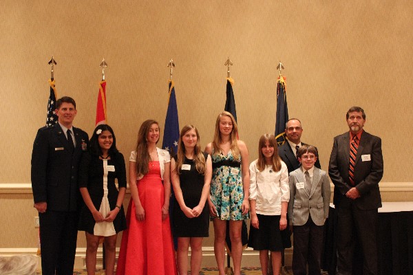 The May scholarship dinner brings together (l-r) Gen. Dickinson; chapter science fair winners Swapnika Mallipeddi, Elya Courtney, Emma Frantz, Yael Courtney, Rebecca Bloomfield and Matthew Johns; Lt. Col. Ares Koumis, USAF (Ret.), chapter science fair coordinator; and Herb Coyer, science fair Junior Teacher of Merit recipient.